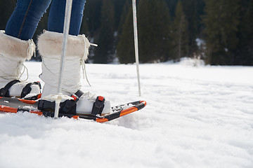 Image showing couple having fun and walking in snow shoes