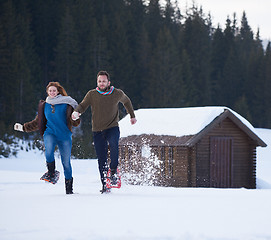 Image showing couple having fun and walking in snow shoes