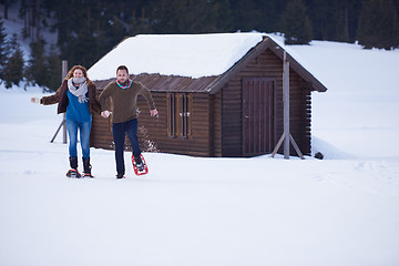 Image showing couple having fun and walking in snow shoes