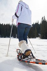 Image showing couple having fun and walking in snow shoes