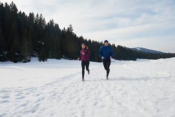 Image showing couple jogging outside on snow