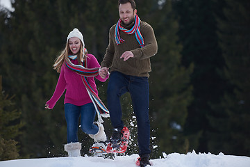 Image showing couple having fun and walking in snow shoes