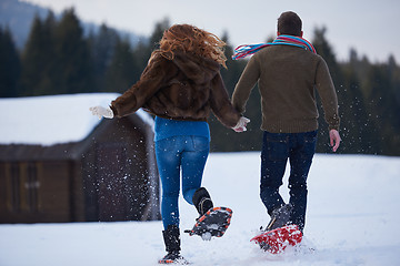 Image showing couple having fun and walking in snow shoes