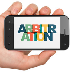 Image showing Law concept: Hand Holding Smartphone with Arbitration on  display
