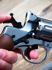 Image showing revolver with the hammer cocked in his hand