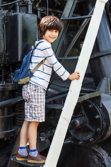Image showing child-researcher on the stairs of an old steam locomotive