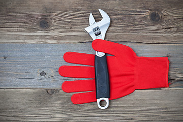 Image showing Red construction glove with wrench
