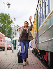 Image showing smiling pretty middle-aged woman goes in a retro trip