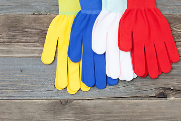 Image showing four gloves on old wood boards