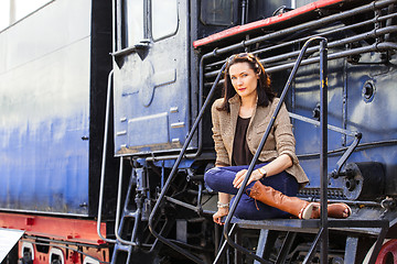 Image showing beautiful woman near an old steam locomotive