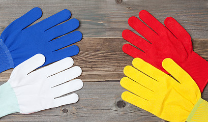 Image showing four new working multicolored gloves