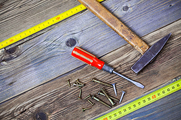 Image showing Vintage hammer, screwdriver, screws and measuring tape