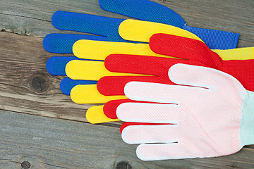 Image showing four colored construction gloves