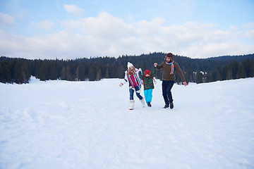 Image showing happy family playing together in snow at winter