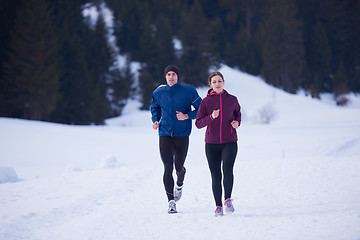 Image showing couple jogging outside on snow