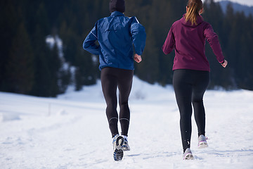 Image showing couple jogging outside on snow