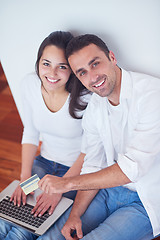 Image showing relaxed young couple working on laptop computer at home