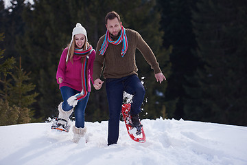 Image showing couple having fun and walking in snow shoes