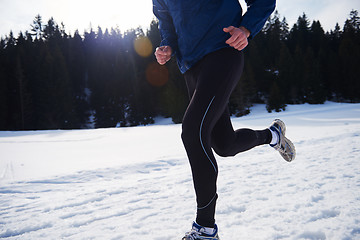 Image showing jogging on snow in forest