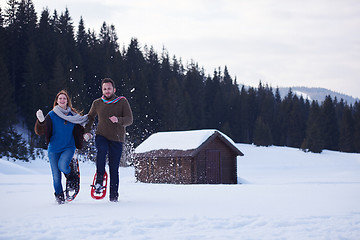 Image showing couple having fun and walking in snow shoes