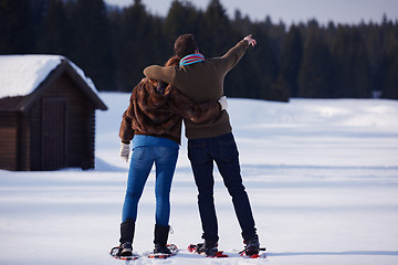 Image showing couple having fun and walking in snow shoes