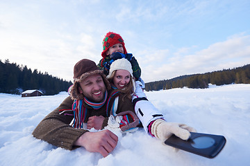 Image showing romantic couple have fun in fresh snow and taking selfie