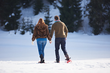 Image showing couple having fun and walking in snow shoes