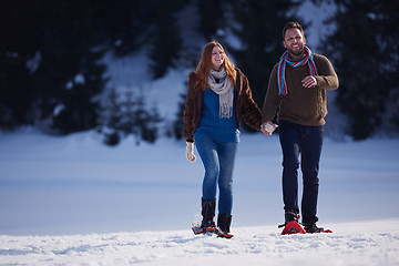 Image showing couple having fun and walking in snow shoes