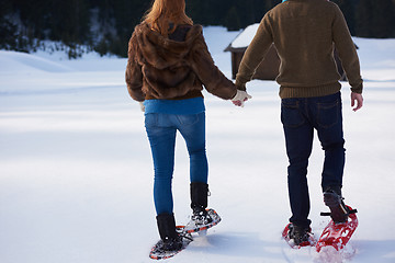 Image showing couple having fun and walking in snow shoes