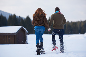 Image showing couple having fun and walking in snow shoes