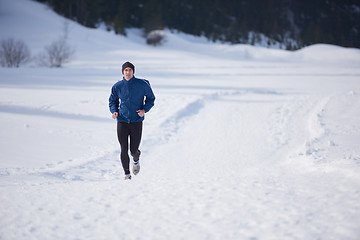 Image showing jogging on snow in forest