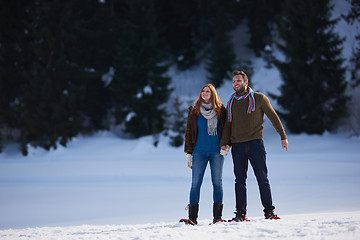 Image showing couple having fun and walking in snow shoes