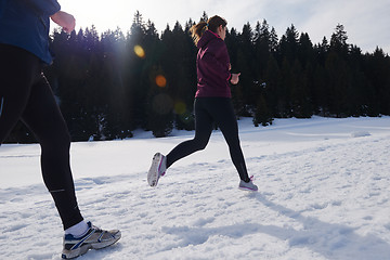 Image showing couple jogging outside on snow