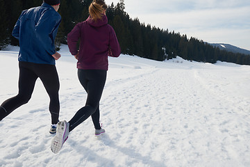 Image showing couple jogging outside on snow