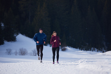 Image showing couple jogging outside on snow