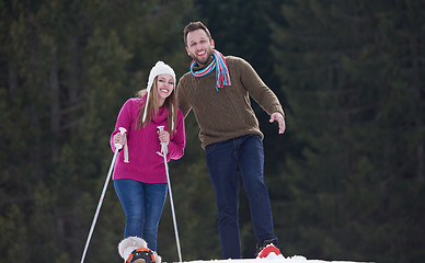 Image showing couple having fun and walking in snow shoes