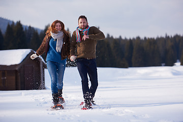 Image showing couple having fun and walking in snow shoes