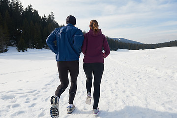 Image showing couple jogging outside on snow