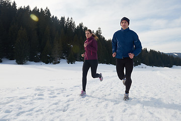 Image showing couple jogging outside on snow