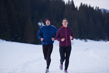 Image showing couple jogging outside on snow