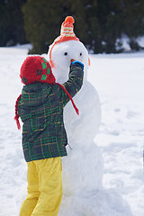 Image showing boy making snowman