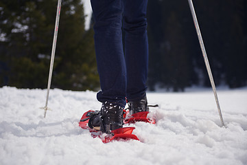 Image showing couple having fun and walking in snow shoes