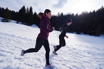 Image showing couple jogging outside on snow