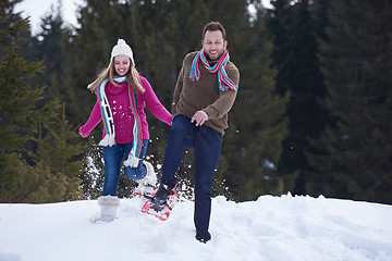 Image showing couple having fun and walking in snow shoes