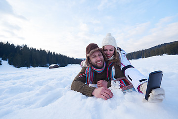 Image showing romantic couple have fun in fresh snow and taking selfie