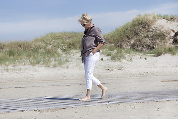 Image showing Vacationer walking on beach path