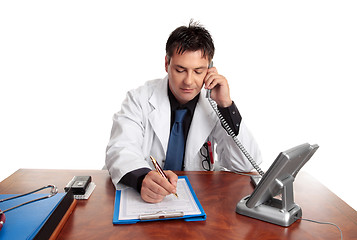 Image showing Doctor filling out patient record