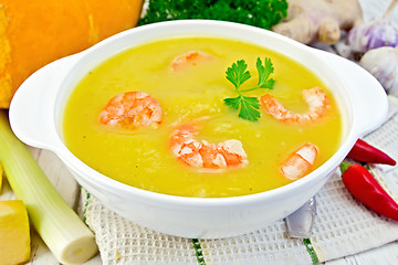 Image showing Soup-puree pumpkin with shrimp in white bowl on table