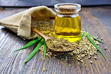 Image showing Flour hemp in spoon with grain and oil on board