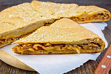 Image showing Pie with cabbage and sesame on board